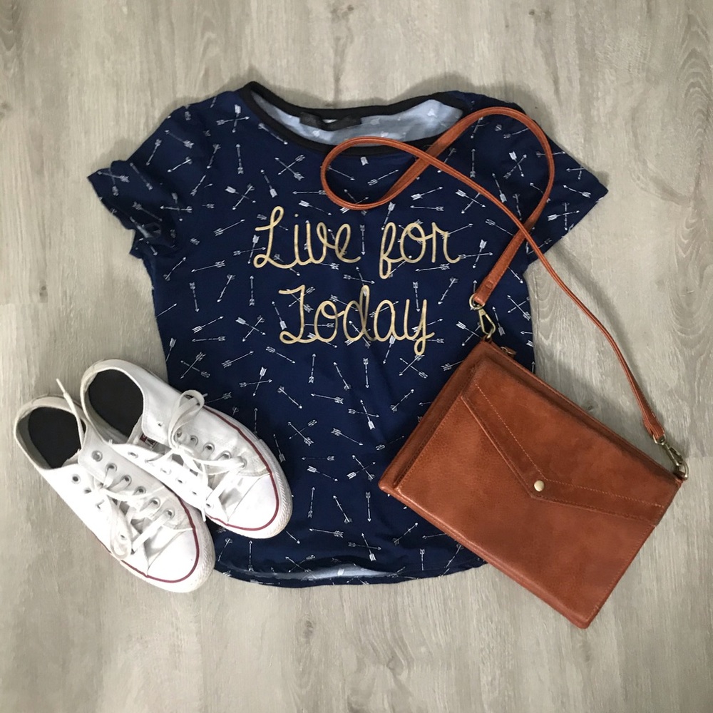 dark blue top with small arrows and a saying